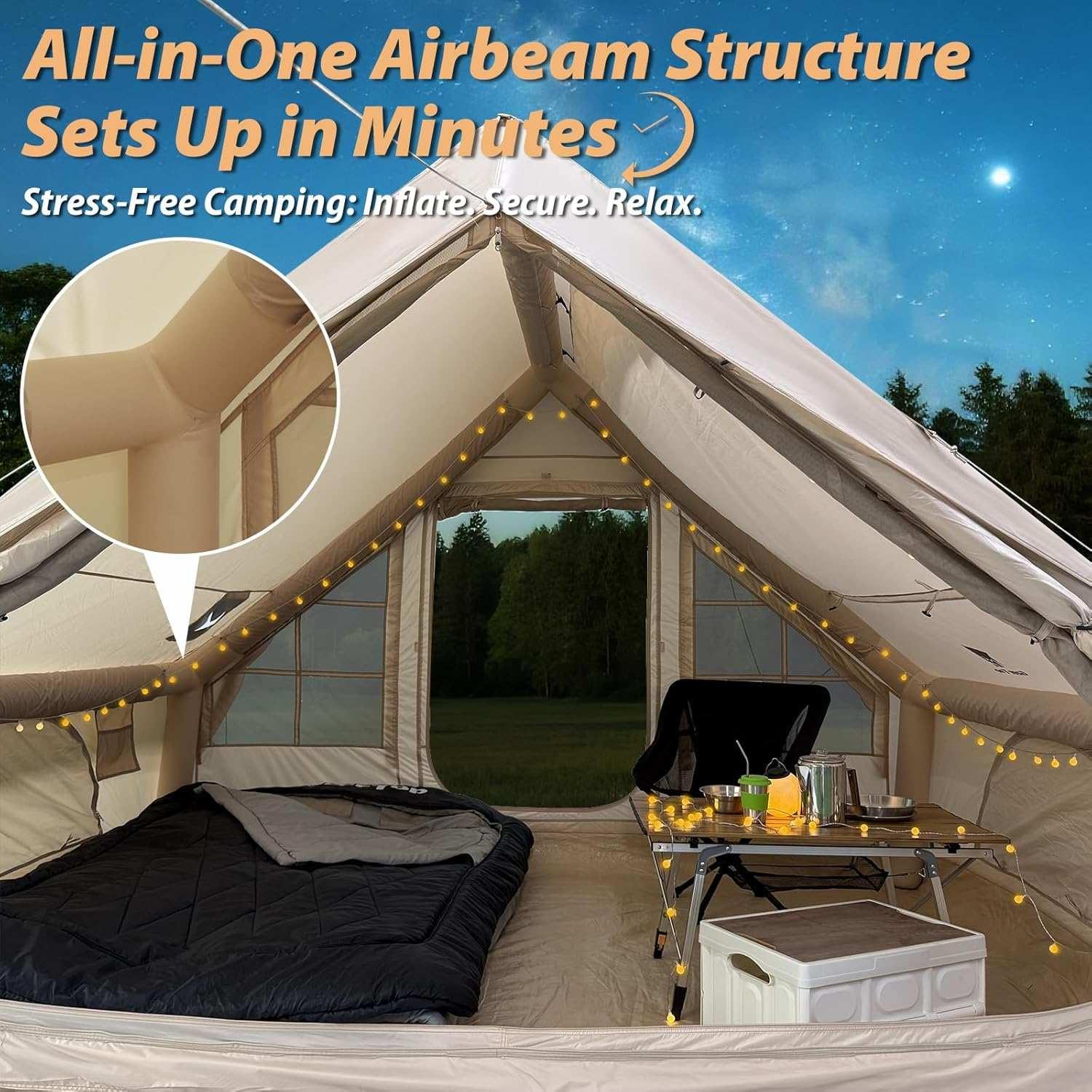 Interior view of all-in-one inflatable airbeam camping tent with sleeping bag, chair, table, and string lights