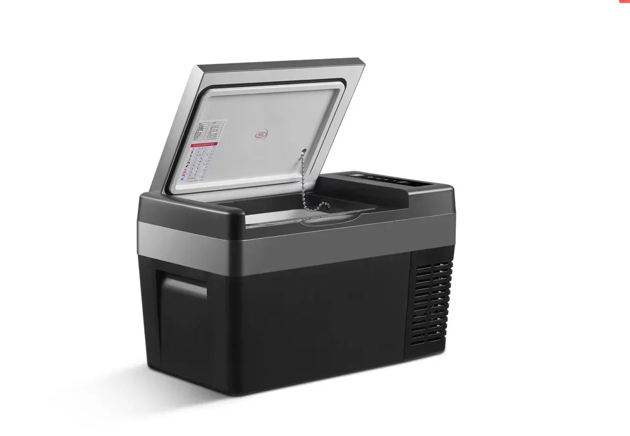 Portable black and silver car refrigerator with open lid on white background